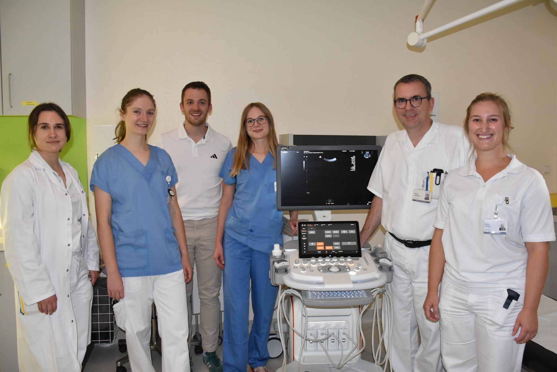 Ärzte und Pflegekräfte stehen vor einem Ultraschallgerät in einem Krankenhaus in Österreich.